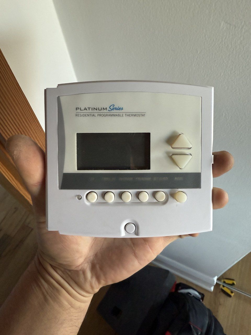 Technician installing thermostat
